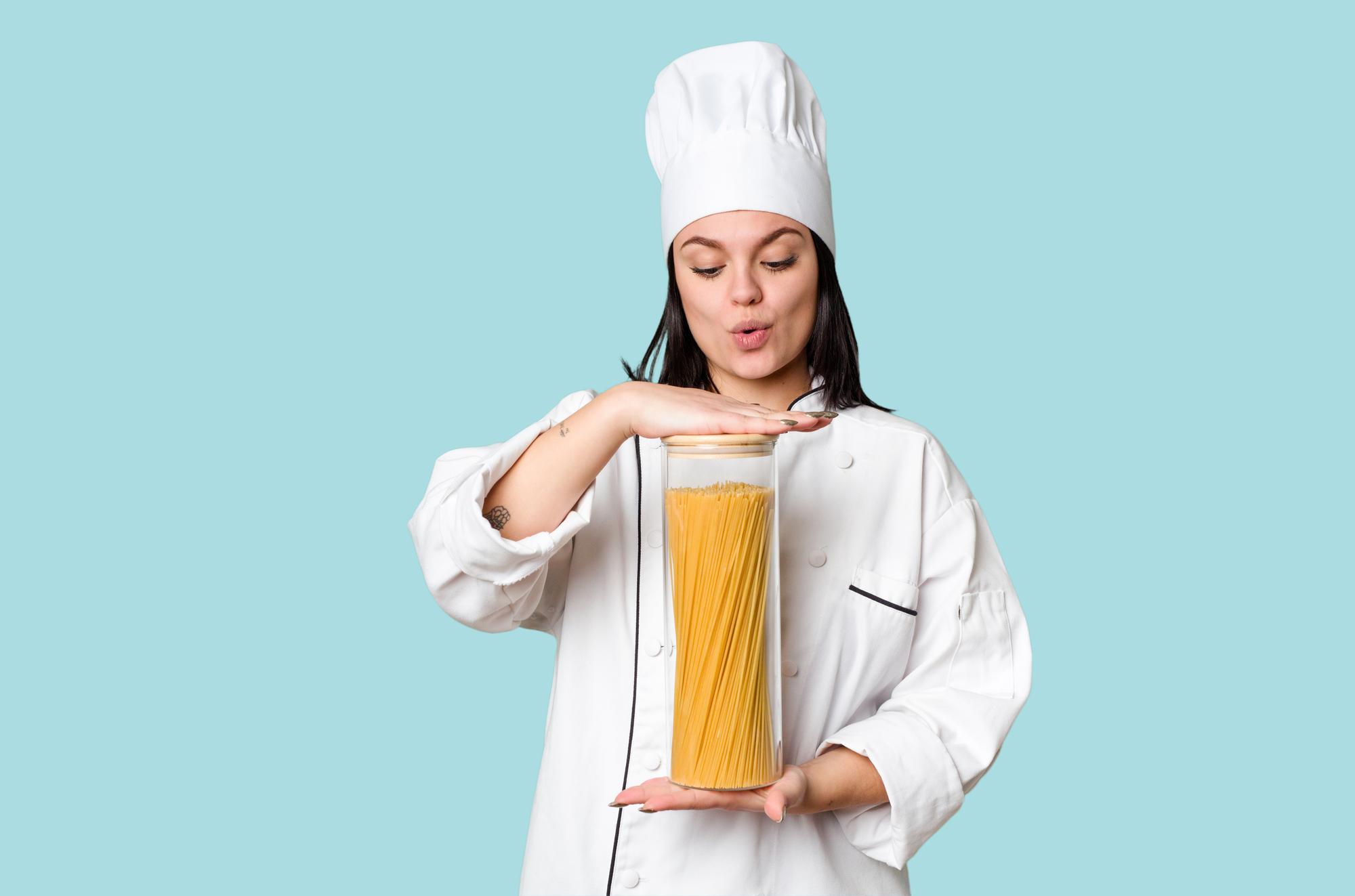 Student cooking pasta with teacher
